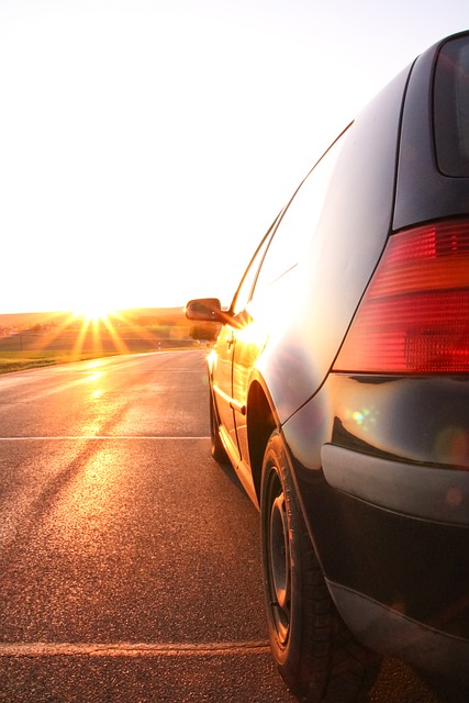 Das Foto zeigt einen Teil eines Autos (Golf) , dass auf einer sonnenbeschienen Straße fährt.